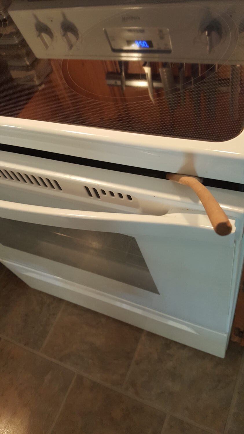 prop oven door with a wooden spoon