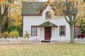 white picket fence around a cottage