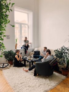 people gathered inside home house sitting on sofa