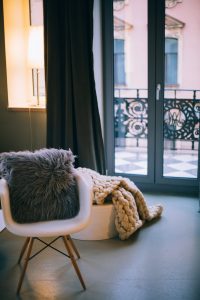 gray throw pillow on white padded armchair home