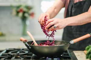 person cooking red cabbage